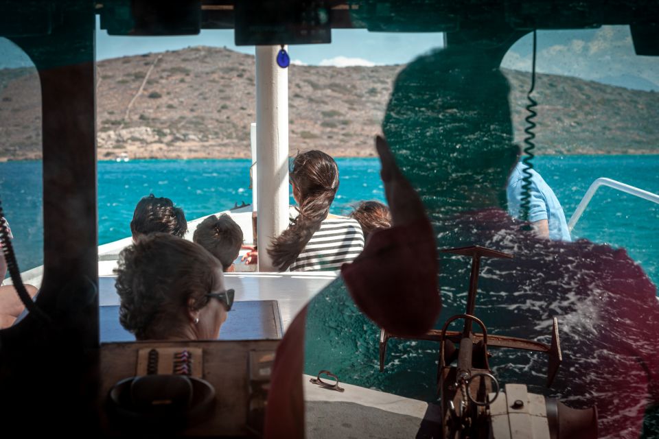 Elounda: Spinalonga Guided Boat Tour with BBQ and Swimming - Crossing toward Spinalonga: views, plus a bit of story